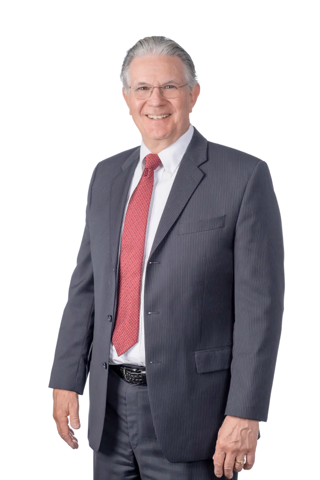 An older man in a suit and red tie smiles at the camera.